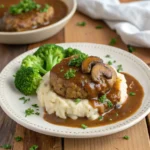 Delicious Salisbury steak recipe with ground chicken served on a plate with mashed potatoes and broccoli"