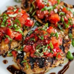 Grilled Bruschetta Chicken topped with fresh tomatoes, basil, and balsamic glaze