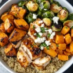 Hot Honey Chicken Bowl with quinoa, roasted sweet potatoes, Brussels sprouts, and feta