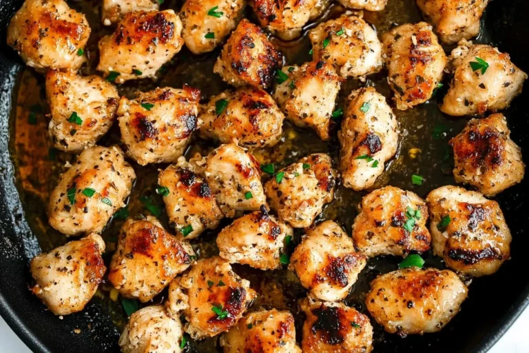 Garlic Butter Chicken Bites sizzling in a skillet, golden and garnished with fresh parsley.