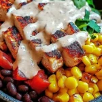 Grilled Chipotle Chicken Bowl with Black Beans and Corn with Creamy Sauce served in a rustic bowl, garnished with fresh cilantro.