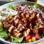 Bowl of Copycat Panera BBQ Chicken Salad with grilled chicken, fresh veggies, pickled onions, and drizzled BBQ and ranch dressing.