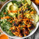 Cilantro Lime Chicken and Rice Bowl with charred chicken, avocado, black beans, corn, cilantro rice, and creamy lime sauce