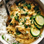 Creamy Lemongrass Chicken with Rice and Zucchini topped with fresh cilantro and sliced zucchini in a bowl.