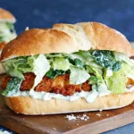 Crispy Chicken Caesar Sandwich with crunchy lettuce and creamy Caesar dressing on a fresh sandwich roll.