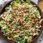 Fresh and colorful Chicken Cashew Crunch Salad topped with creamy tahini dressing, roasted cashews, and shredded rotisserie chicken.