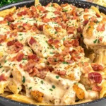 Creamy Crack Chicken Penne with bacon and parsley in a skillet