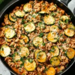 Ground Turkey and Zucchini Skillet with sautéed zucchini rounds and savory ground turkey in a flavorful sauce, garnished with fresh parsley.
