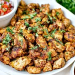 Keto Chipotle Chicken served on a white platter, garnished with fresh cilantro and paired with pico de gallo.