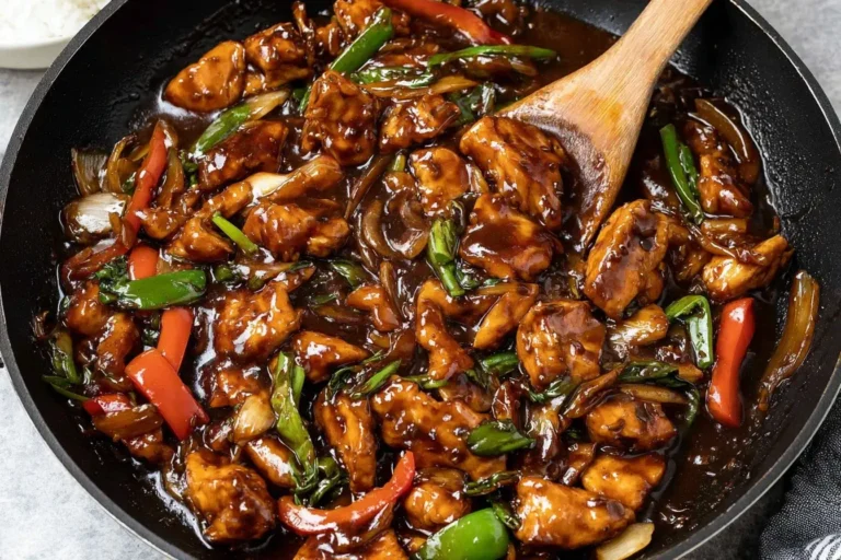 Chicken in Garlic Sauce Chinese sizzling in a pan with peppers and onions