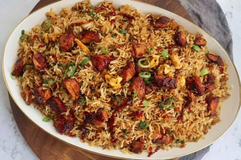 BBQ Chicken Fried Rice with a Japanese BBQ glaze, garnished with green onions, served on an oval platter.