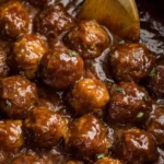 Slow Cooker Salisbury Steak Meatballs simmering in rich brown gravy in a slow cooker