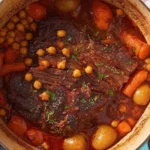 Indian Butter Pot Roast with chickpeas, carrots, and potatoes in a Dutch oven