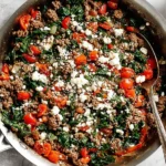 Mediterranean Ground Beef Stir-Fry with spinach, cherry tomatoes, and feta cheese served in a skillet.