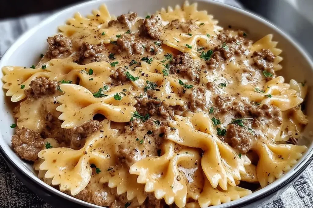 Creamy Parmesan Garlic Beef Bowtie Pasta topped with fresh parsley in a creamy garlic parmesan sauce.