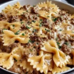 Creamy Parmesan Garlic Beef Bowtie Pasta topped with fresh parsley in a creamy garlic parmesan sauce.