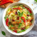 Spring Roll Salad with Spicy Ginger Dressing, featuring rice noodles, fresh vegetables, and herbs.