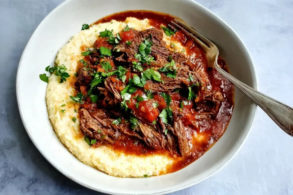 Italian Pot Roast served over creamy polenta with fresh herbs