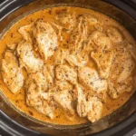 Slow Cooker Honey Mustard Chicken cooked in creamy sauce inside a crockpot