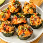 Baked Salmon Sushi Cups with spicy mayo, seaweed, and rice on a white plate