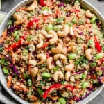 Close-up of Thai Quinoa Salad with cashews, red cabbage, edamame, and bell peppers in a bowl