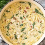 Creamy White Lasagna Soup in a Dutch oven with chicken, spinach, and mafalda pasta.