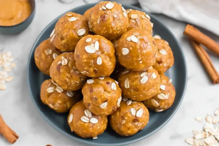 Homemade pumpkin protein balls topped with oats on a plate