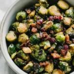 Maple Bacon Brussels Sprouts in a ceramic bowl with crispy bacon and caramelized edges, a sweet and savory holiday side dish.