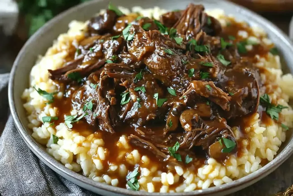 Slow Braised Pot Roast with Creamy Parmesan Risotto topped with rich brown gravy, tender beef, and fresh parsley for a hearty comfort meal.