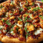 Golden-crusted Chili Garlic Chicken Pizza topped with melted cheese, spicy chili-garlic sauce, and fresh cilantro for the ultimate homemade flavor.