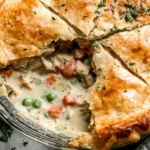 A beautifully baked chicken pot pie filled with tender chicken, vegetables, and a creamy sauce, wrapped in a flaky, golden crust. Perfect for weeknight comfort or entertaining.