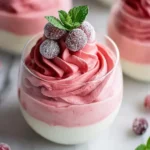 Cranberry Mousse Cups with creamy layered cranberry and vanilla mousse topped with sugared cranberries and mint.