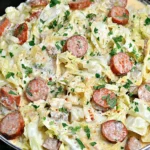 Keto TikTok Cajun Sausage Cabbage Alfredo in a skillet—creamy cabbage, Andouille sausage slices, Parmesan cream sauce, and parsley.