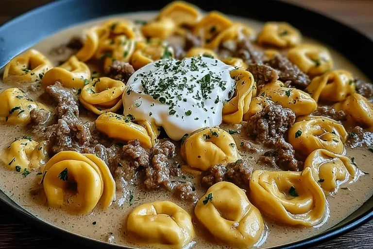 Skillet Beef Stroganoff Tortellini served in a creamy sauce with tender ground beef, cheese-filled tortellini, and a dollop of sour cream.