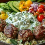 Mediterranean Gyro Bowls with juicy seasoned chicken meatballs, fluffy quinoa, fresh cucumbers, tomatoes, and creamy homemade tzatziki sauce