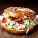 California BLT Chopped Bagel stuffed with chopped bacon, romaine, tomato, chive-onion cream cheese, and diced avocado on an everything bagel.