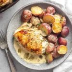 Chicken and Potatoes with Dijon Cream Sauce served in a bowl—golden seared chicken breast with roasted red baby potatoes and creamy Dijon mustard sauce.