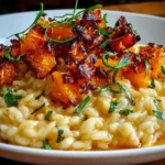 Roasted Butternut Squash Risotto in a white bowl—creamy Arborio rice topped with caramelized roasted squash cubes and fresh herbs.