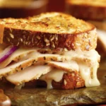 Turkey Dijon Melt Sandwiches with sliced turkey, melted Monterrey Jack, and red onion on crispy toasted multigrain bread