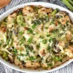 Creamy Asparagus Chicken Casserole baked with tender chicken, asparagus, mushrooms, and melted cheese in a rich creamy sauce.