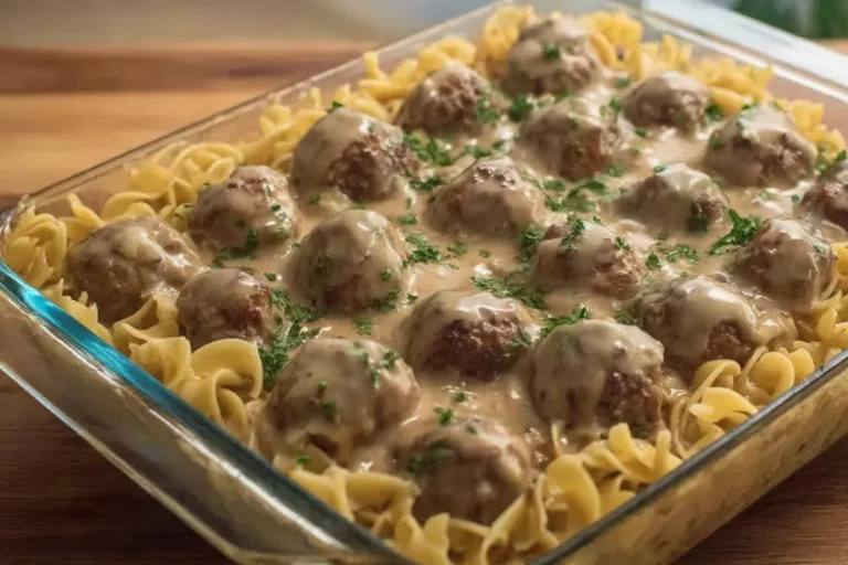 Swedish Meatball Noodle Bake in a glass casserole dish with egg noodles, creamy mushroom sauce, and tender meatballs topped with parsley.