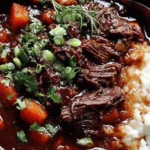 Korean Style Pot Roast served over mashed potatoes with carrots, rich gochujang-braised beef, and green onion garnish.