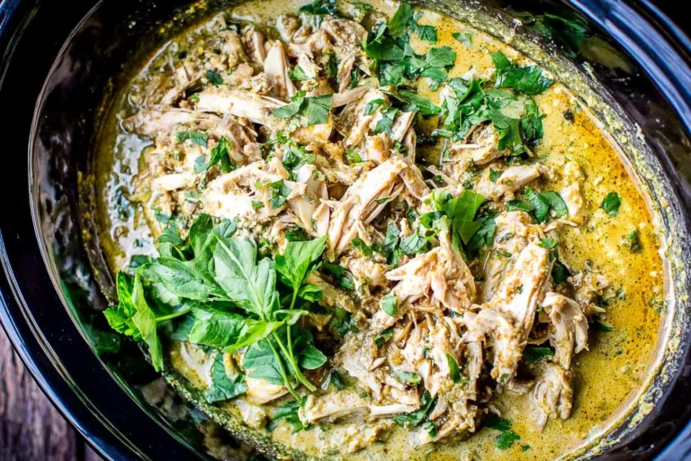 Slow Cooker Basil Chicken Coconut Curry in a crockpot with tender shredded chicken in creamy coconut curry sauce, topped with fresh basil and cilantro.