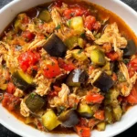 Slow Cooker Ratatouille with Chicken in a white bowl—shredded chicken with zucchini, eggplant, peppers, and tomatoes in a rich sauce.