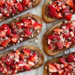 Chocolate Strawberry Bruschetta on toasted sourdough with Nutella cream cheese, fresh diced strawberries, and crunchy walnut topping.