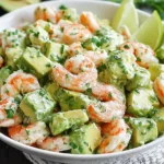 Avocado Shrimp Salad in a white bowl with creamy avocado chunks, tender shrimp, fresh herbs, and lime wedges.