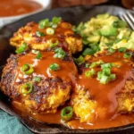 Spicy Sweet Chicken Diablo plated in a cast-iron skillet—crispy seared chicken topped with glossy spicy-sweet sauce and green onions, served with a creamy side.