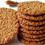 Biscoff Oatmeal Cookies stacked on a plate with cookie butter spread, showing golden-brown, chewy oat texture.