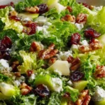 Ina Garten Cape Cod Salad Recipe with crisp greens, diced Granny Smith apple, dried cranberries, toasted walnuts, and crumbled blue cheese.