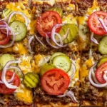 Cheeseburger Flatbreads topped with seasoned ground beef, melted cheese, sliced pickles, tomatoes, and red onion on a crispy flatbread crust.